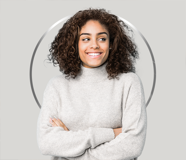 Young smiling woman with dark hair wearing a grey jumper