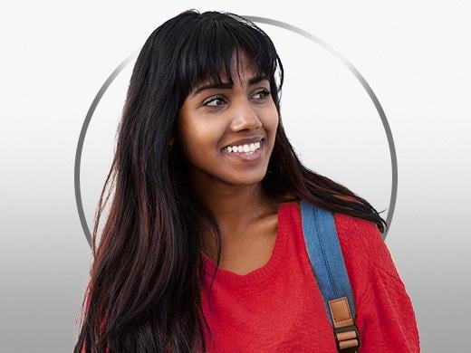 Smiling young woman with dark hair, wearing a red shirt, happy after Canesten cystitis treatment
